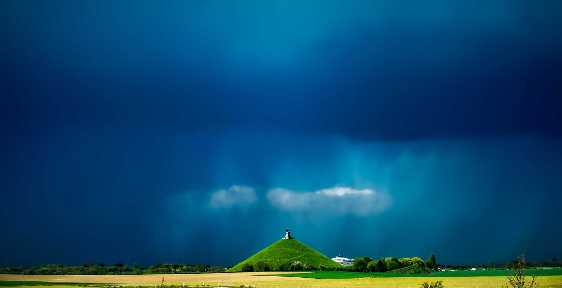 Field of Grass Landscape with a hill in the background