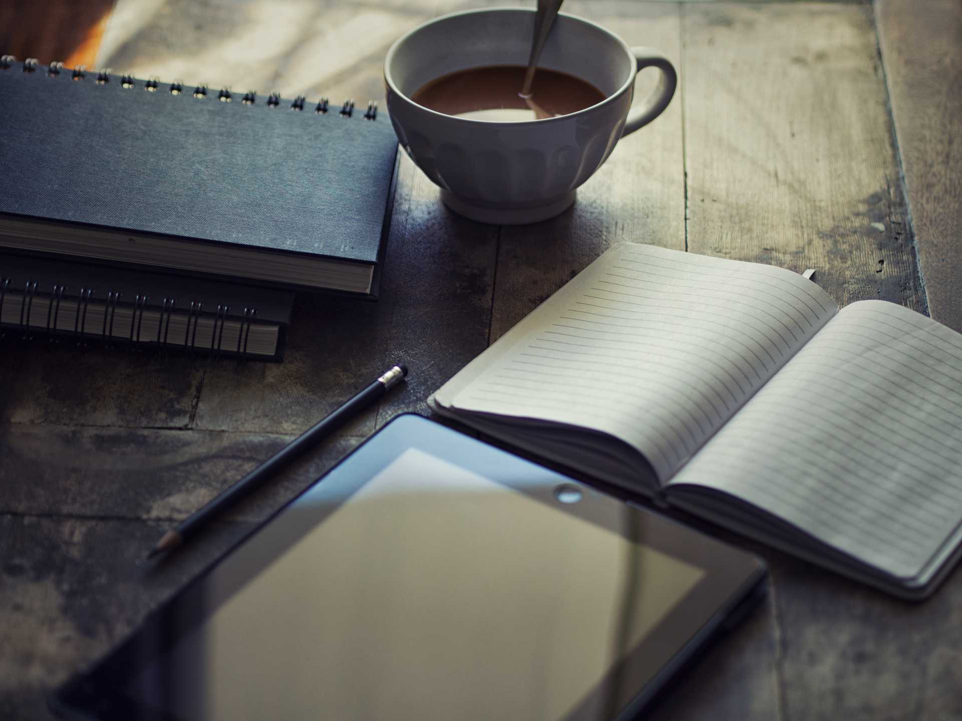 Cup Filled With Coffee Near Notebook and Tablet