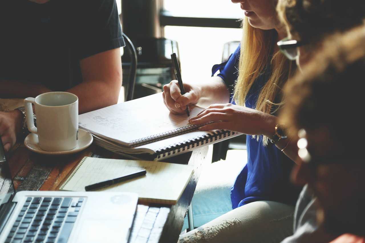 People with coffee at a meeting