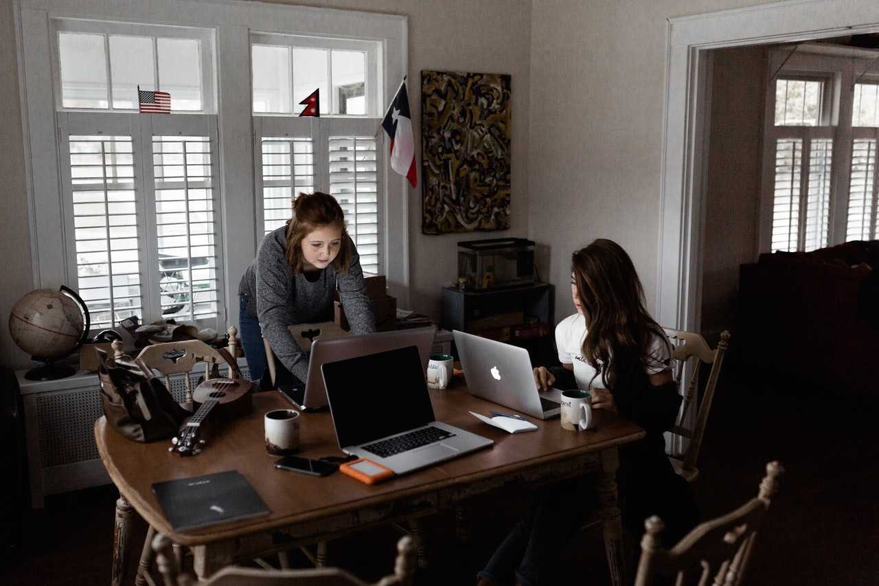 Two programmers at work at a table